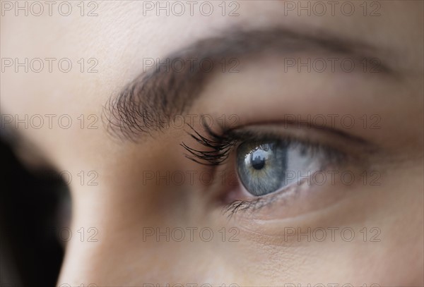 Close up of young woman with blue eyes.