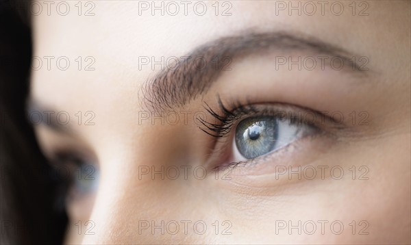 Close up of young woman with blue eyes.