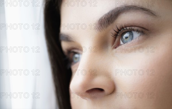 Close up of young woman with blue eyes.