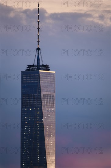 One World Trade Center against dramatic sky at dusk. USA, New York, New York City.