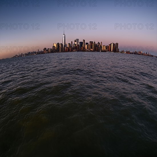 Urban skyline at dusk. USA, New York, New York City.