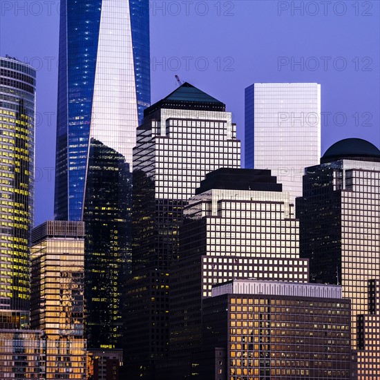 Urban skyline and One World Trade Centre at dusk. USA, New York, New York City.