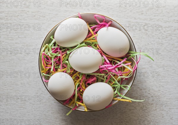 Eggs in bowl and colorful streamers