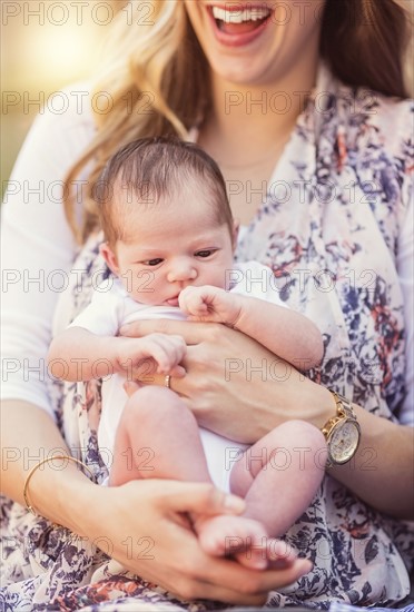 Mother holding daughter (2-5 months)