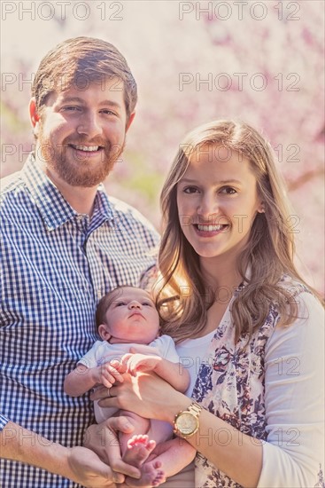 Portrait of happy family with baby girl (2-5 months)