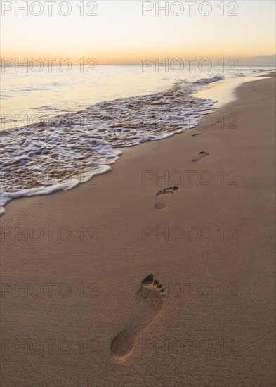 Footprints on sand on tropical beach