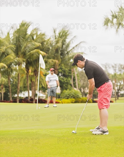 Two men playing golf