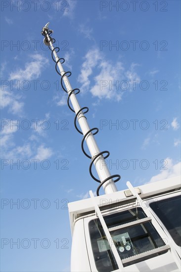 Pole of news van against sky