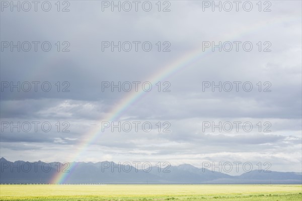Rainbow over agricultural field