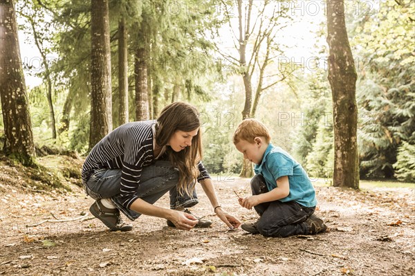 Mother playing with son (2-3) in park