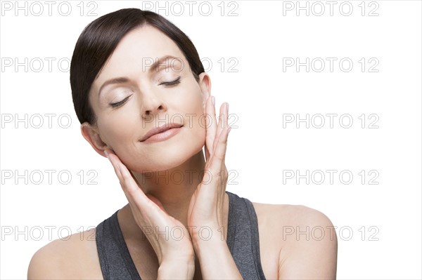 Woman with eyes closed on white background