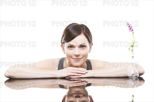Portrait of woman leaning on mirror