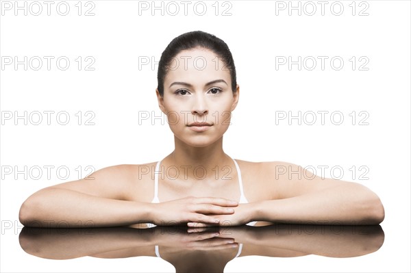 Portrait of woman leaning on mirror
