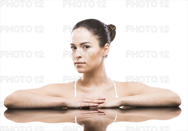 Portrait of woman leaning on mirror