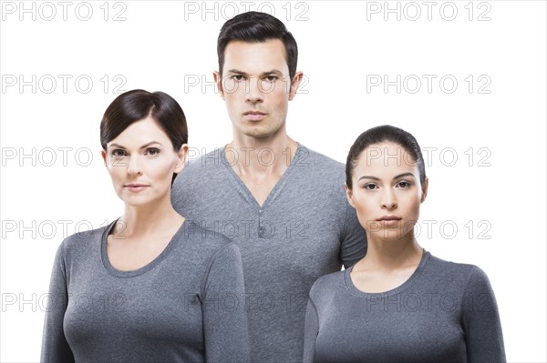 Man and two women wearing grey tops