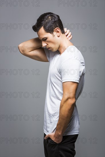 Man in white t-shirt on grey background