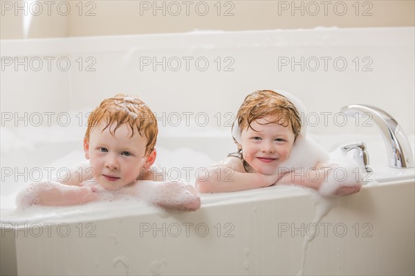 Sister and brother (2-3, 4-5) having bubble bath