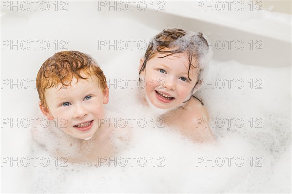 Sister and brother (2-3, 4-5) having bubble bath