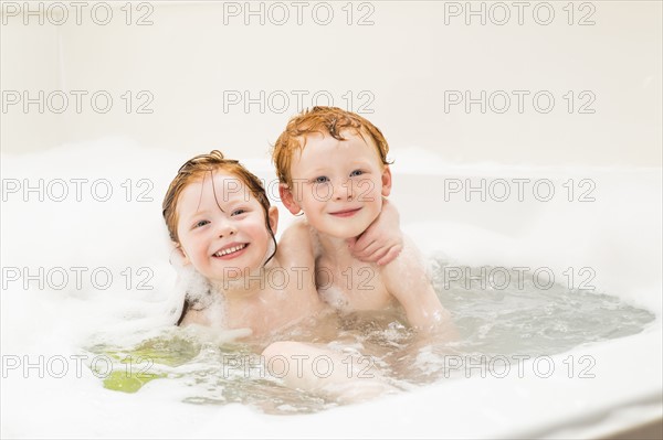 Sister and brother (2-3, 4-5) having bubble bath