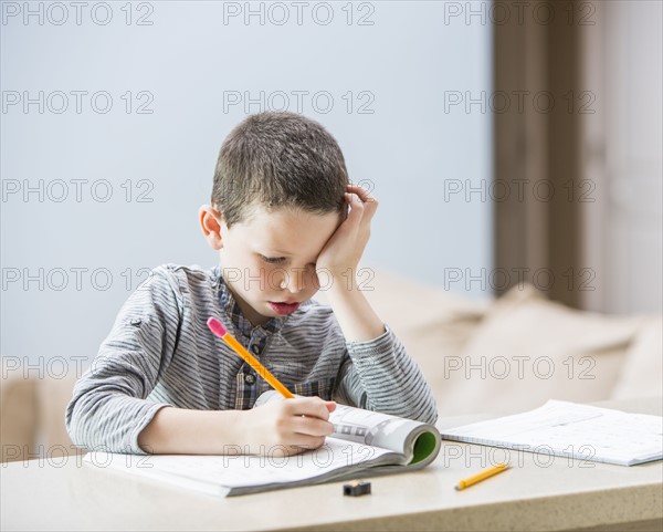 Boy (6-7) doing homework