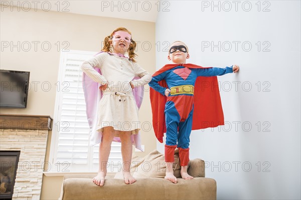 Children (2-3, 4-5) playing superhero on sofa