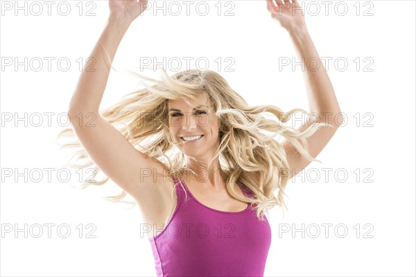 Smiling blonde woman dancing