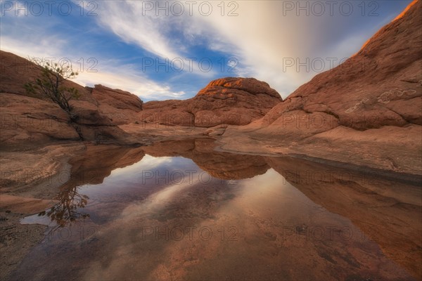 Sandstones reflected in water