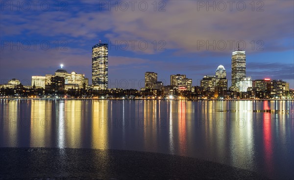 City skyline along Charles River at dusk