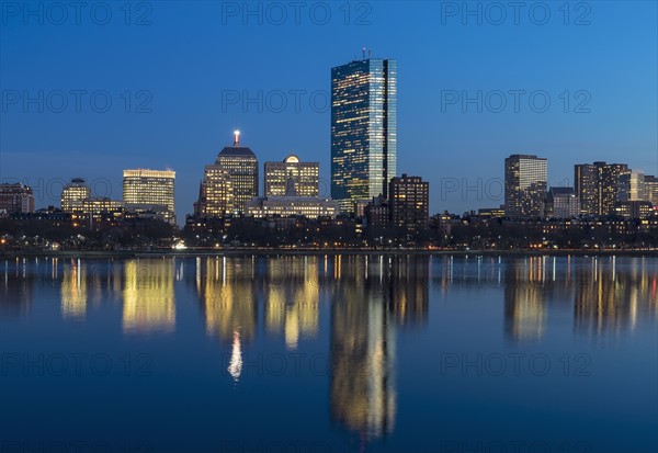 City skyline along Charles River at dusk