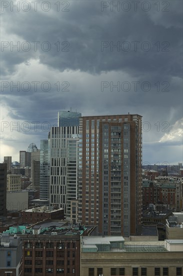 Downtown district against cloudy sky
