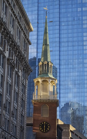 Clock tower against skyscraper in background