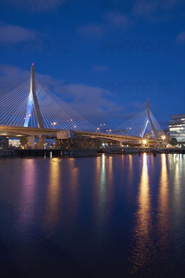 Suspension bridge over river at dusk