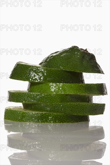 Slices of lime on white background