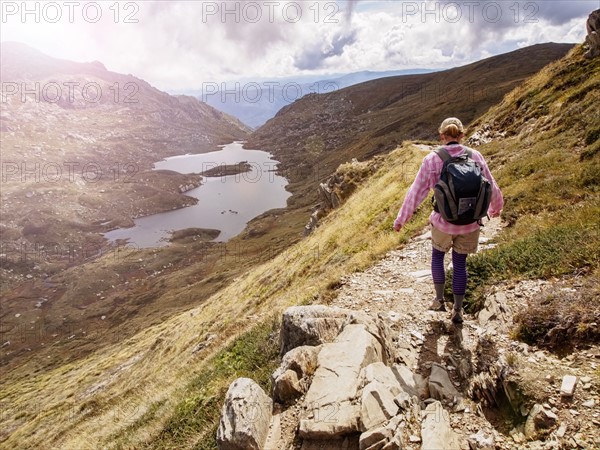 Rear view of hiker on footpath