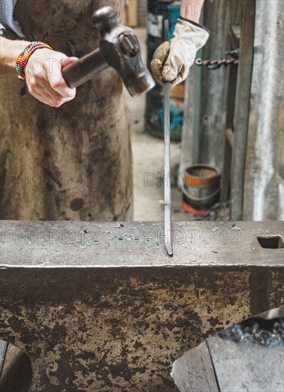 Close up of hand of female blacksmith at work