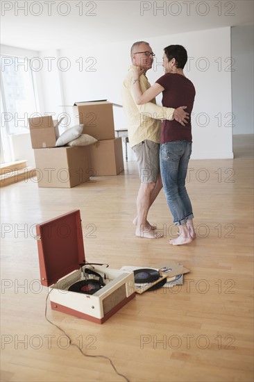 Couple dancing in new apartment.