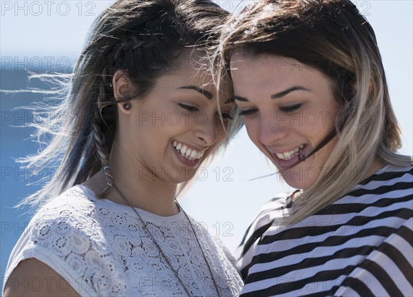 Smiling young women looking down.