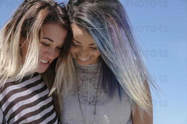 Smiling young women looking down.