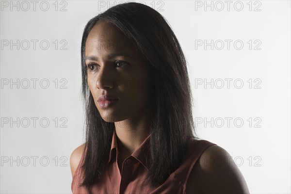 Portrait of mid adult woman against white background.