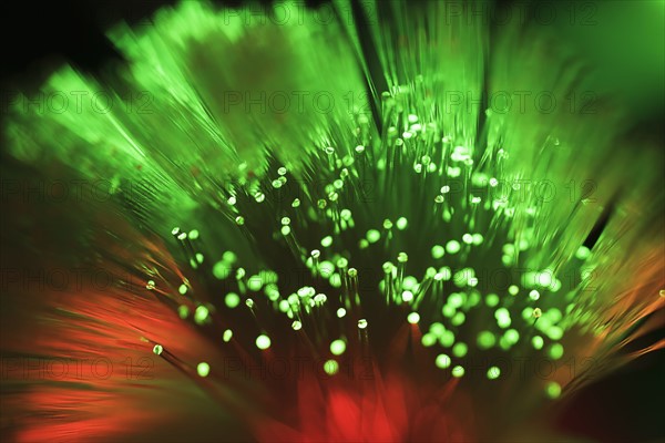 Bunch of glowing red and green fiber optic cables.