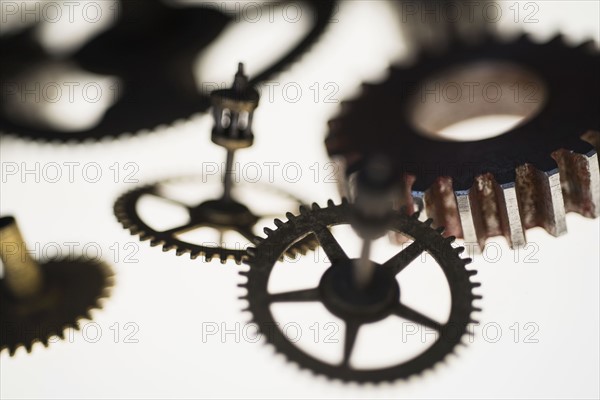 Close-up of metal gears on white background.