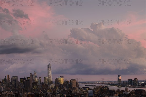 City skyline under dramatic pink sky.