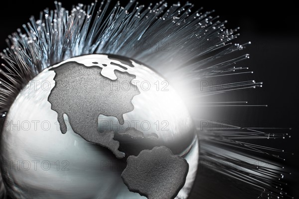 Illustration of fiber optics over globe.