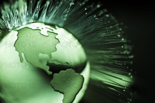 Illustration of fiber optics over globe.