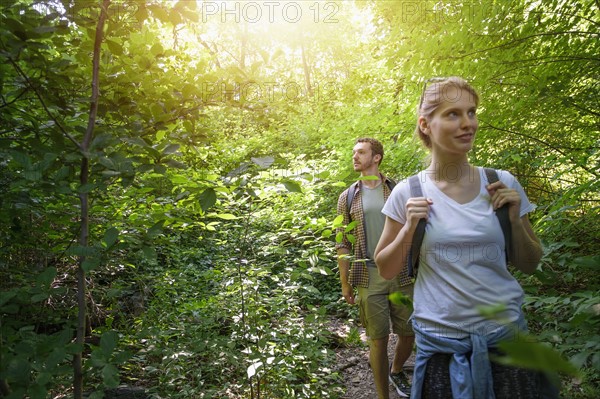 Couple walking in woodlands.