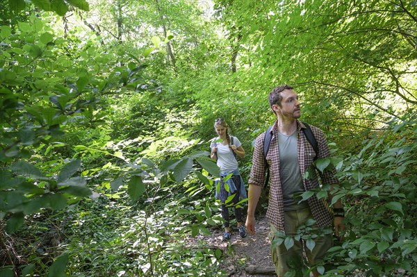 Couple walking in woodlands.