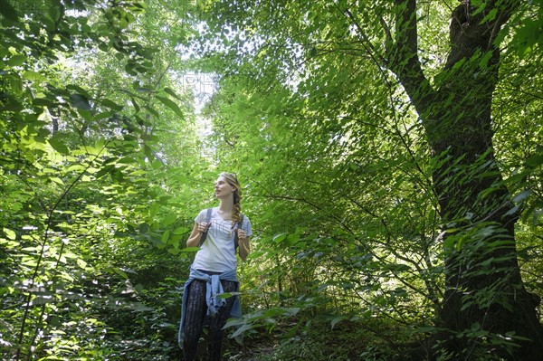 Young woman walking in woodlands.