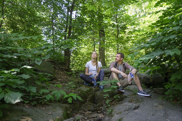 Couple resting in forest.