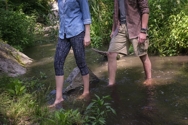 Couple wading in water.