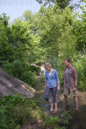 Couple wading in water.